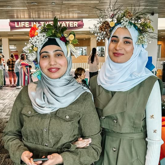 Two women pose for a photo at International Women's Day